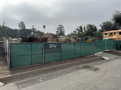 Construction site photo of the Altadena multi-unit fire rebuild on Ganesha Avenue during grading and drainage work