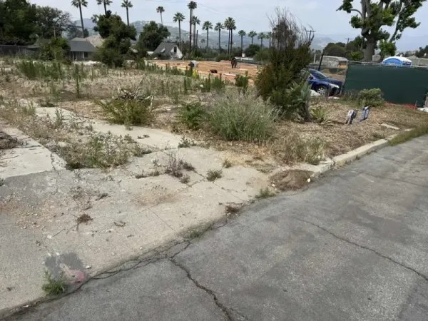 Grading work in progress with erosion control measures and prepared subgrade for slab on grade