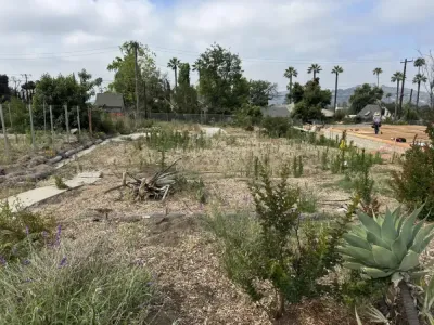 Construction site overview showing prepared building pad and drainage routing for Altadena fire rebuild