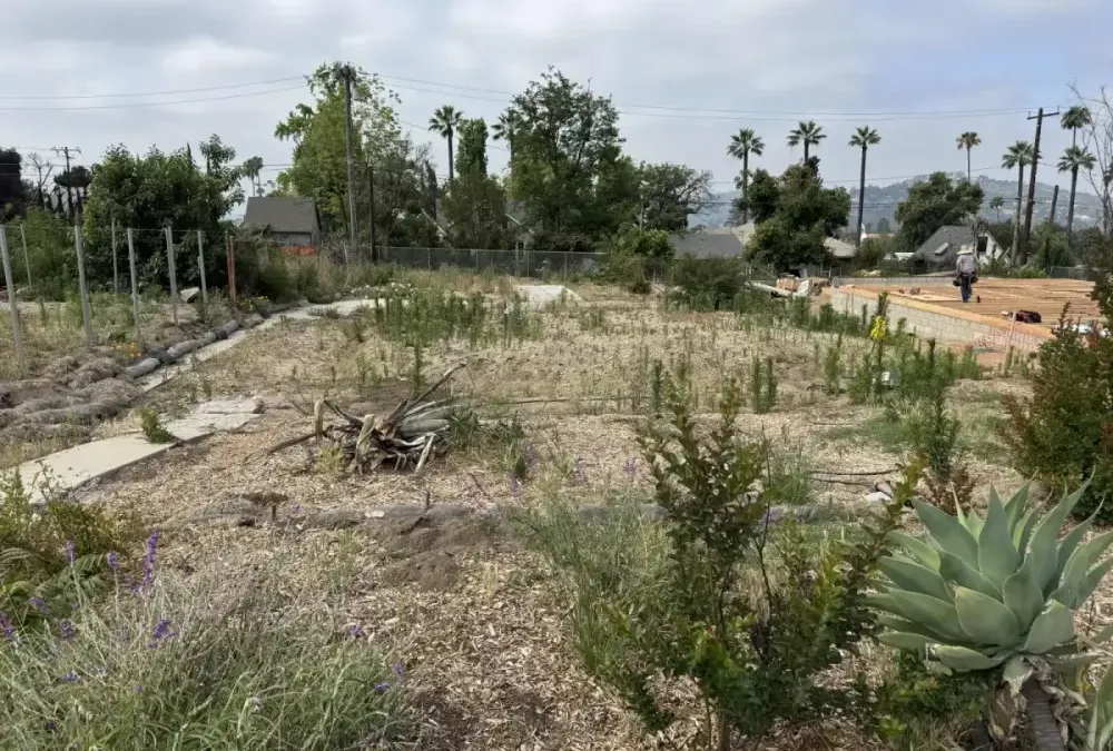 Construction site overview showing prepared building pad and drainage routing for Altadena fire rebuild