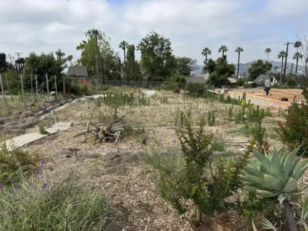 Construction site overview showing prepared building pad and drainage routing for Altadena fire rebuild