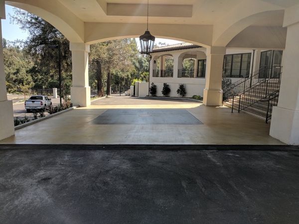 Mediterranean-style entrance portico at Chevy Chase Country Club with decorative landscaping