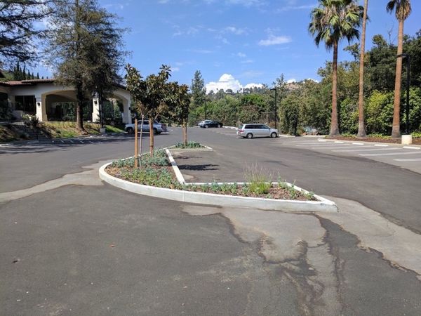Chevy Chase Country Club parking lot with landscaped planters and proper drainage after our grading design