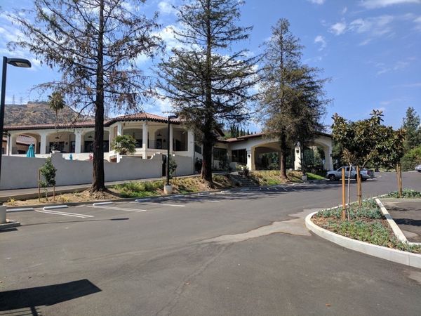Spanish-style Chevy Chase Country Club building with asphalt parking lot following our grading plan